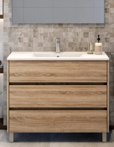 Movel de casa de banho Axis 3 gavetas em melamina de carvalho claro, com lavatório cerâmico de encostar e pés metálicos.